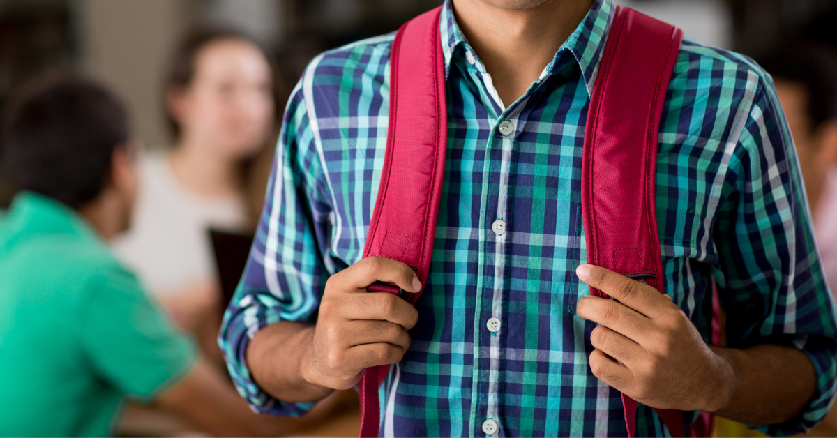 male student wearing a red backpack